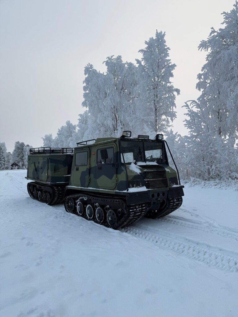 Northern lights trip to wilderness with tracked truck